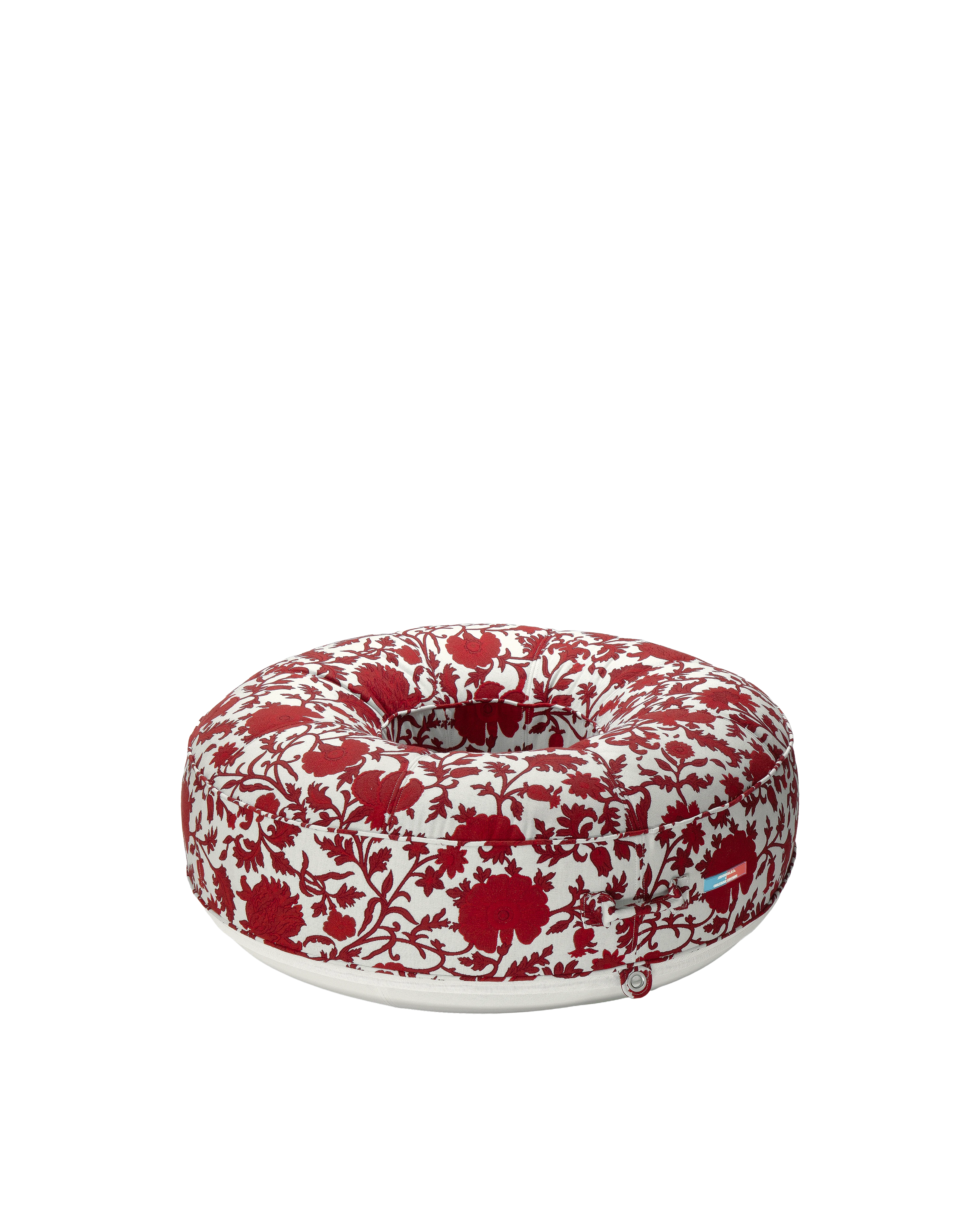 Angle view of a luxury round inflatable pool float with red and white flower jacquard fabric, featuring an open center and tailored upholstered finish.
