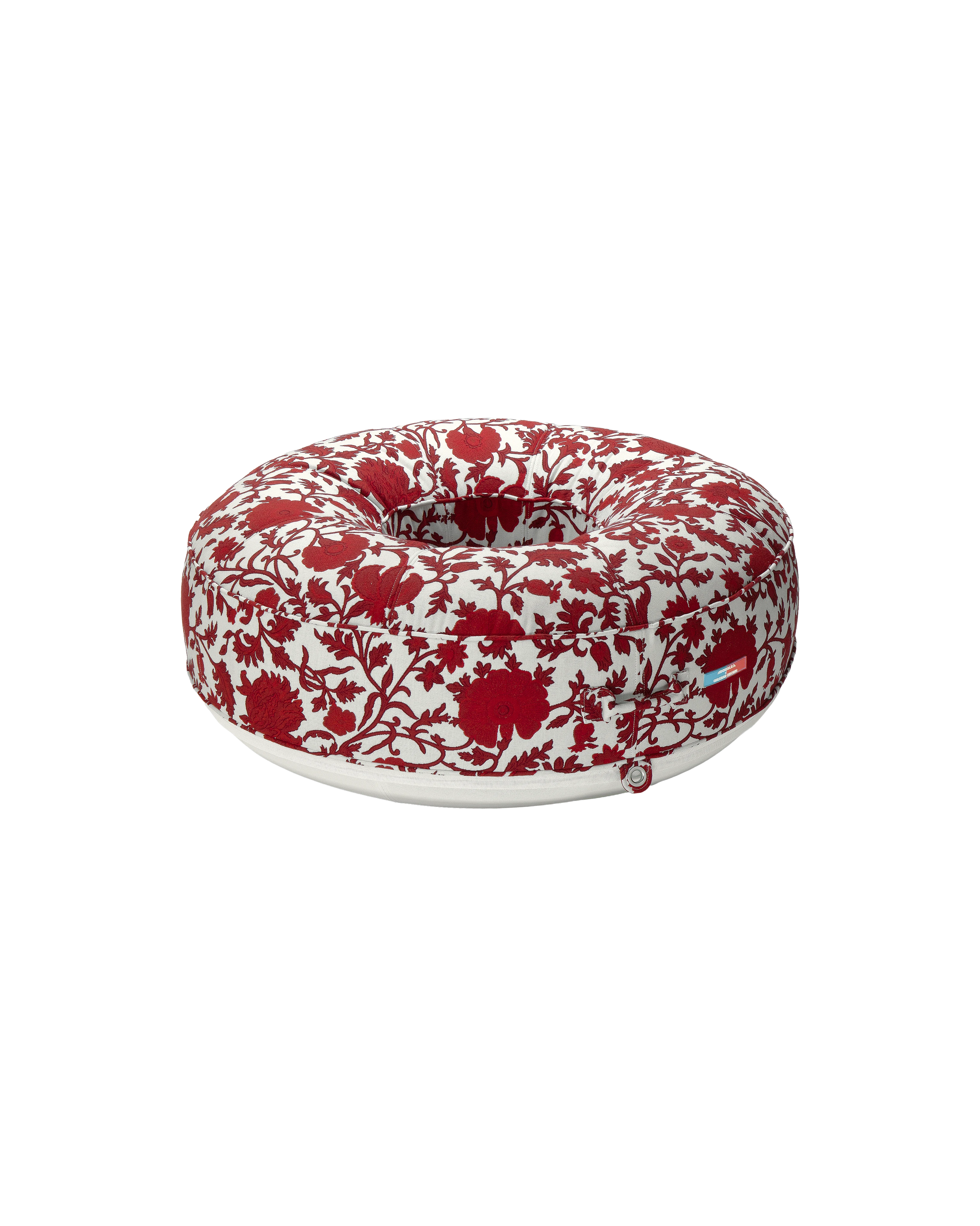 Angle view of a luxury round inflatable pool float with red and white flower jacquard fabric, featuring an open center and tailored upholstered finish.