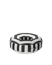 Angle view of a luxury round inflatable pool float with black and white stripes, featuring an open center and tailored upholstered finish.