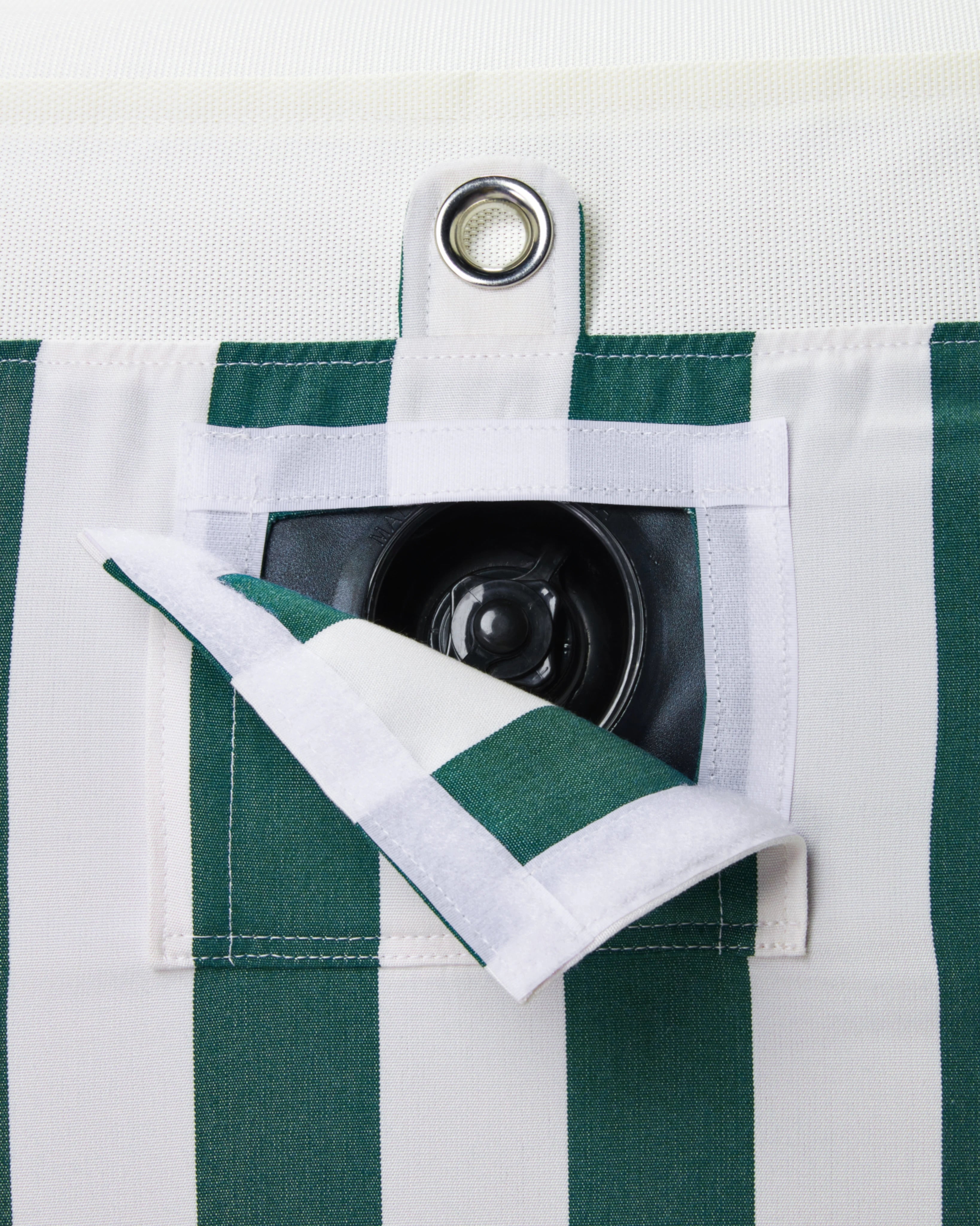 Close-up of concealed inflation valve beneath a neatly stitched flap in green and white striped fabric, highlighting discreet functional design.