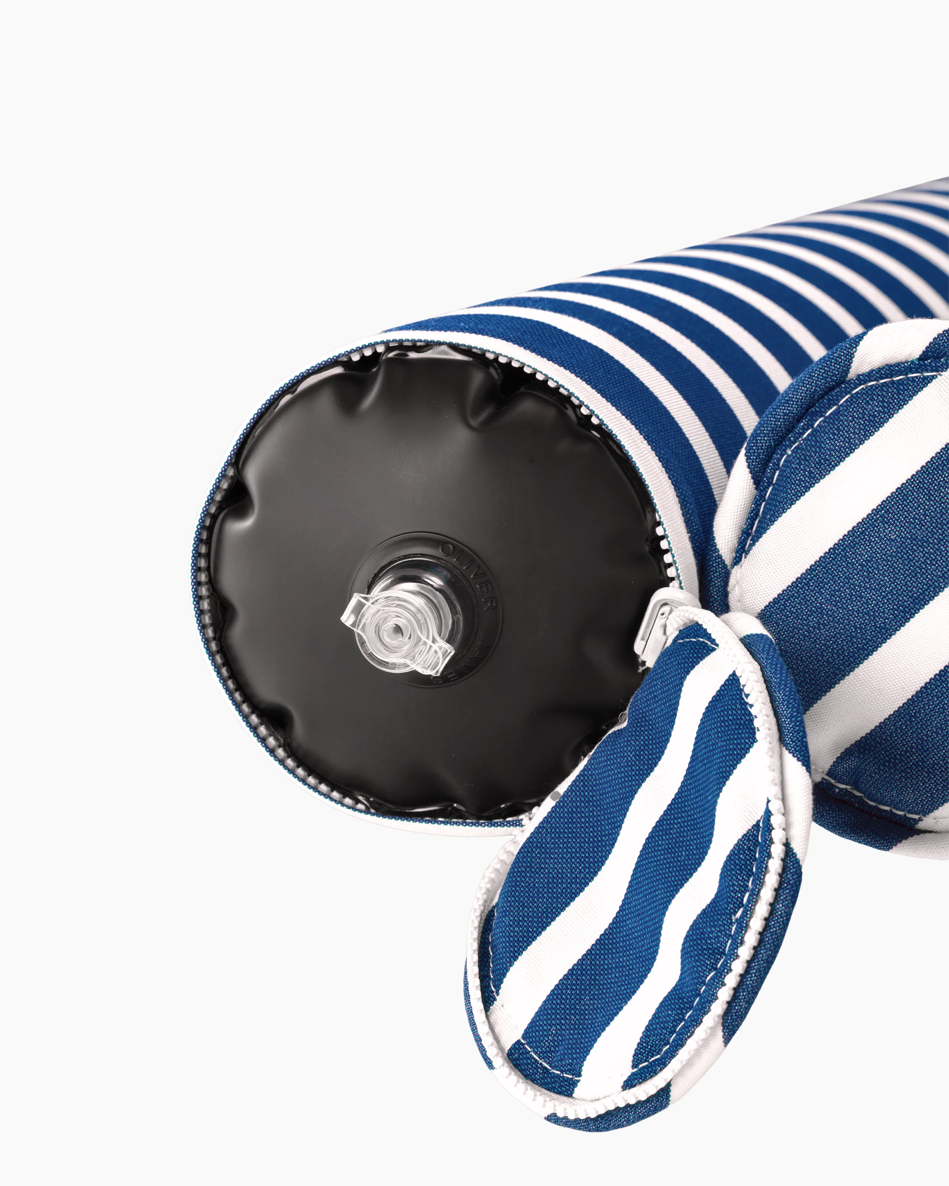 Close-up of the air valve on the end of a striped inflatable bolster, discreetly hidden by a zippered sleeve — refined design meets functional elegance.