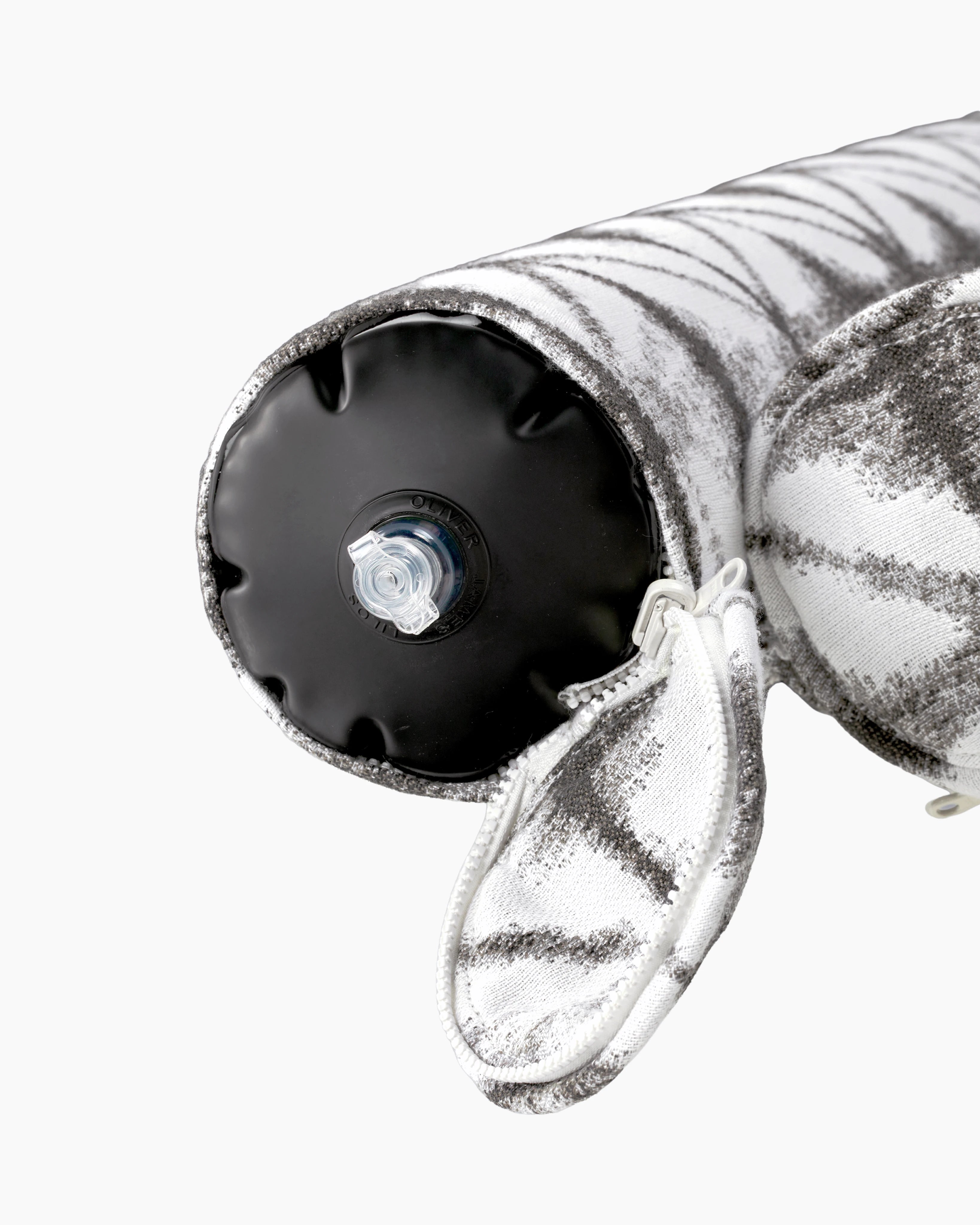 Close-up of the air valve on the end of a grey and white geometric jacquard fabric inflatable bolster, discreetly hidden by a zippered sleeve — refined design meets functional elegance.
