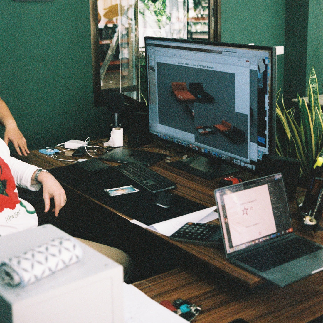 Renders of luxury pool floats on a computer screen in an office.