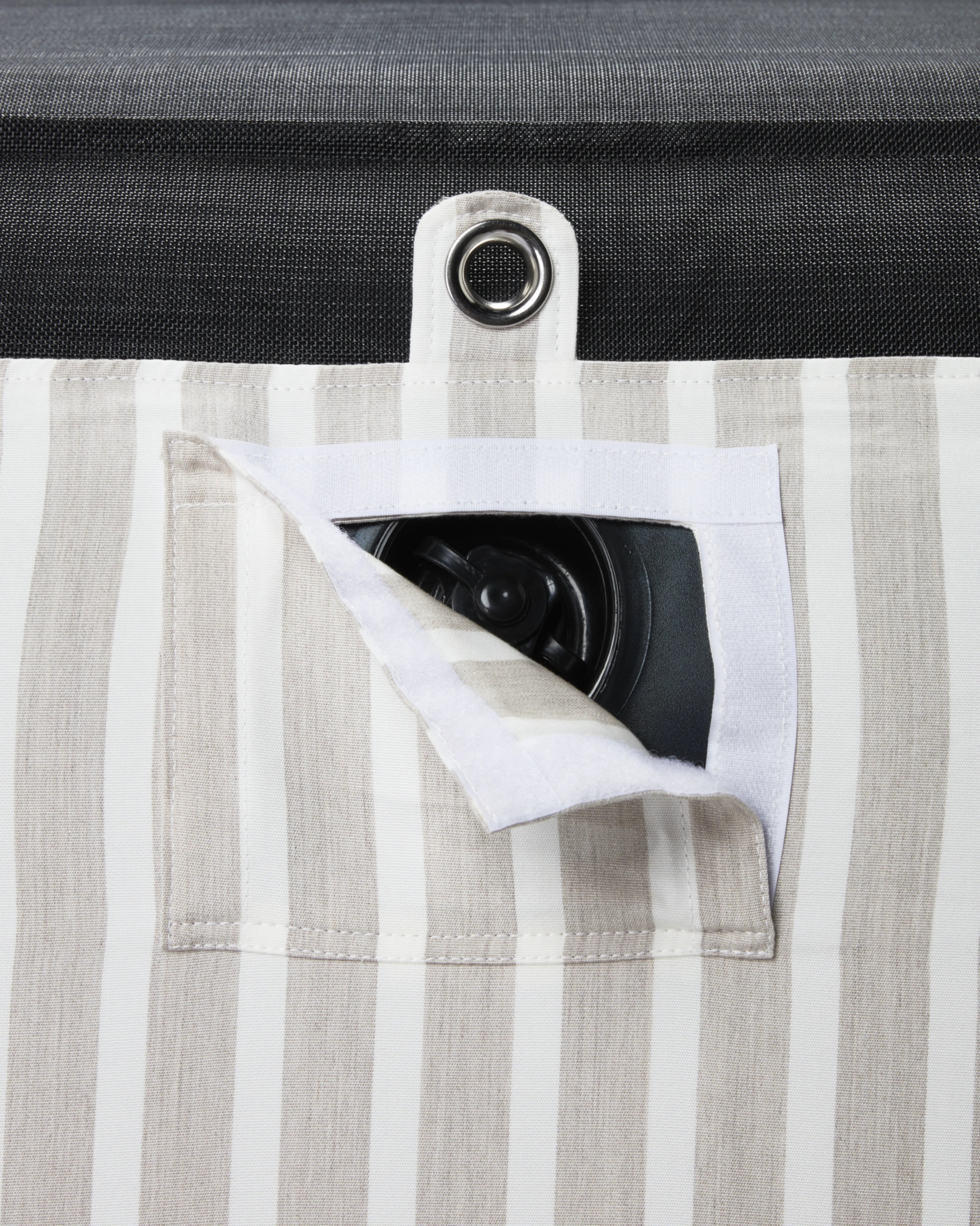 Discreet inflation valve hidden beneath tailored striped fabric — part of a luxury pool float with attention to detail and durable design.
