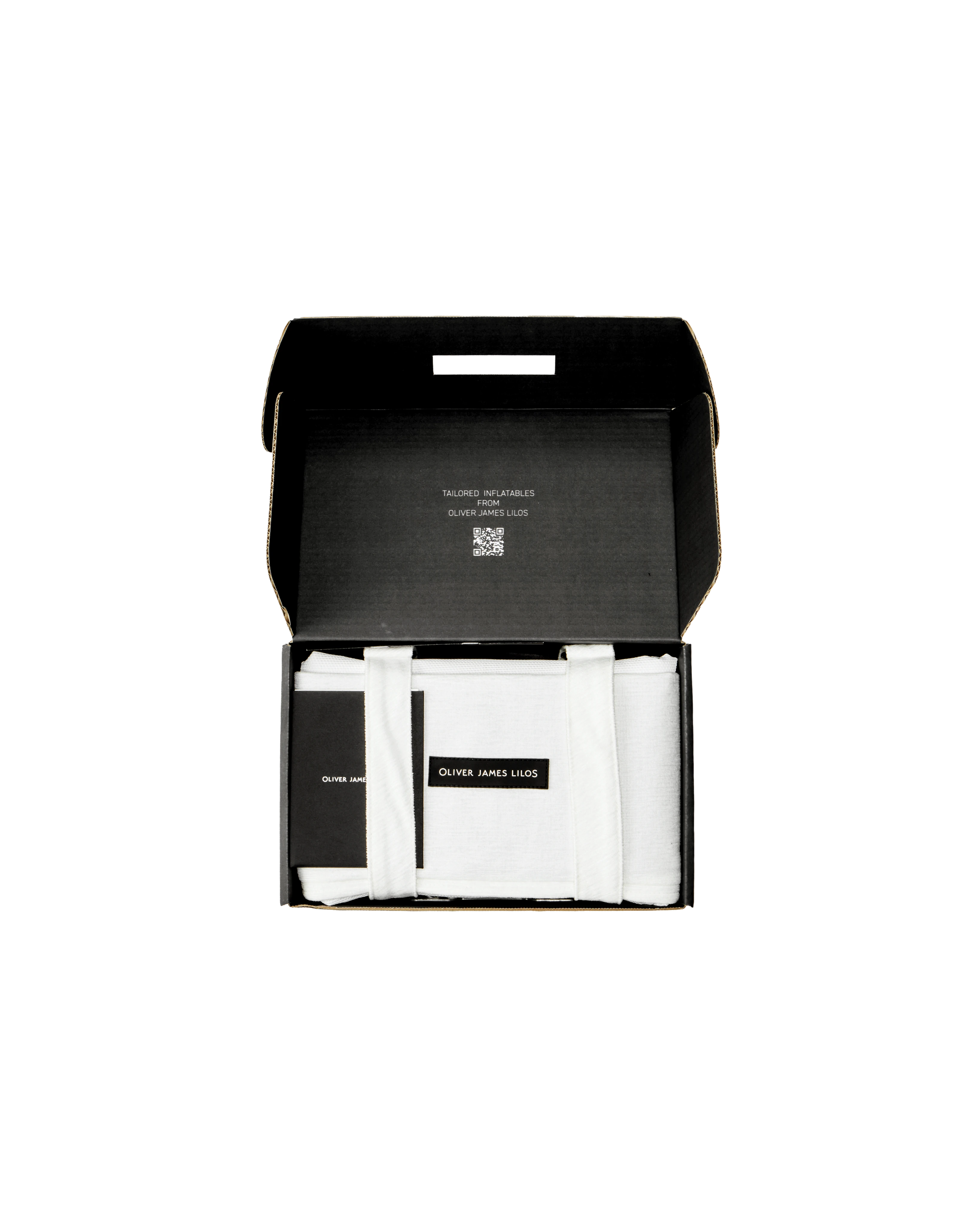 Oliver James floating hammock packed inside a sleek black box, with folded white Chenille fabric bolsters and branded tag — a premium pool float presented with care.