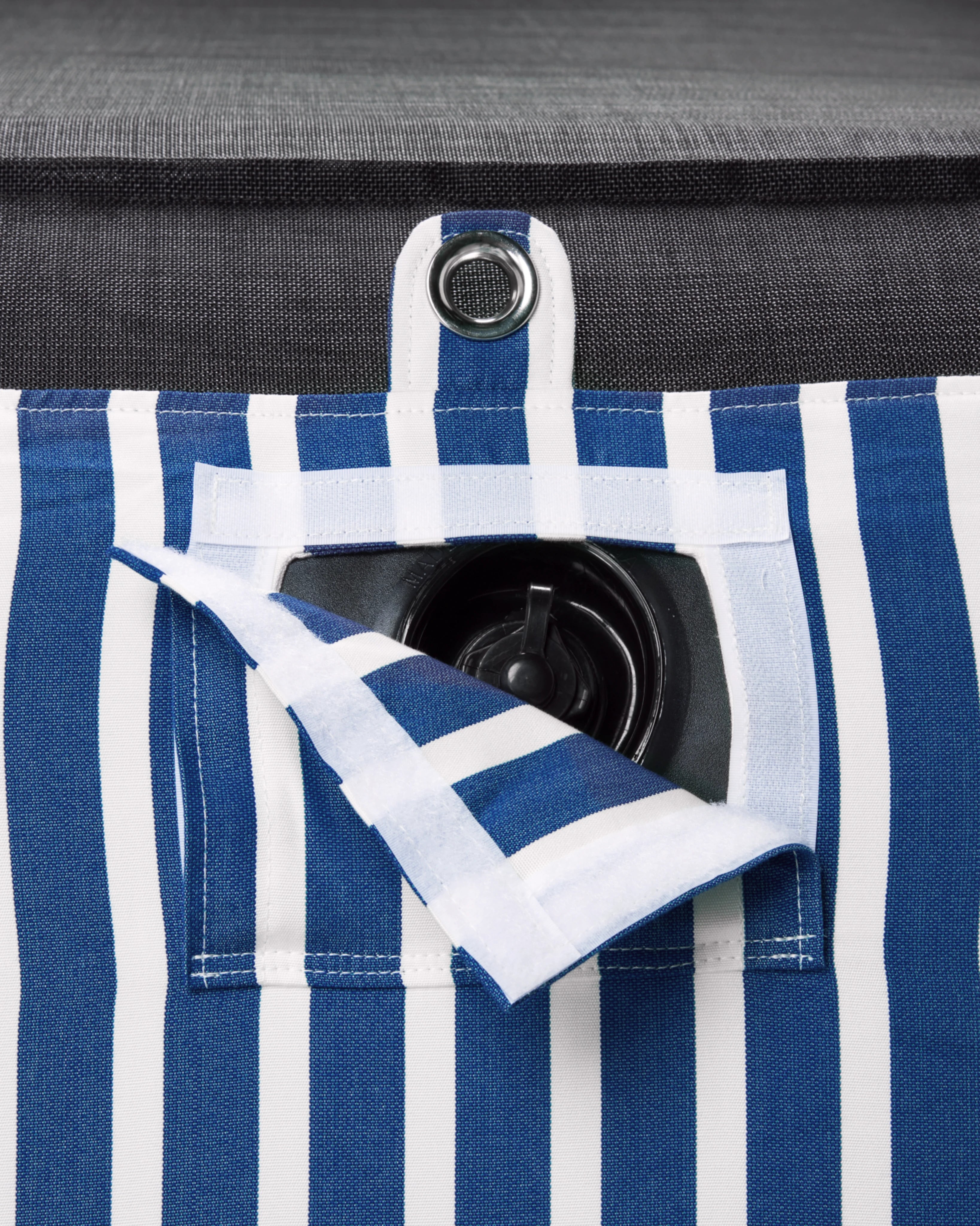 Discreet inflation valve hidden beneath tailored striped fabric — part of a luxury pool float with attention to detail and durable design.