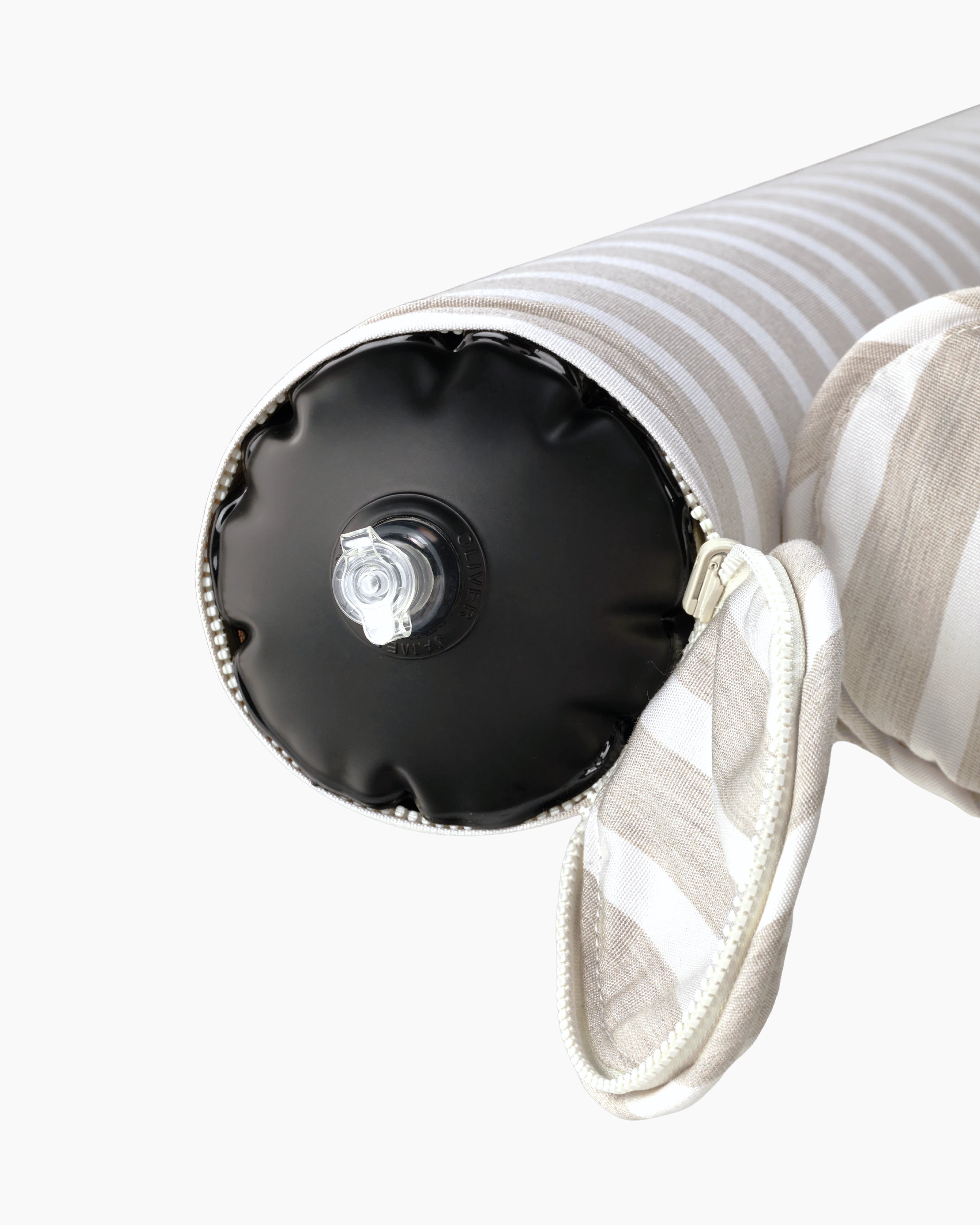 Close-up of the air valve on the end of a striped inflatable bolster, discreetly hidden by a zippered sleeve — refined design meets functional elegance.
