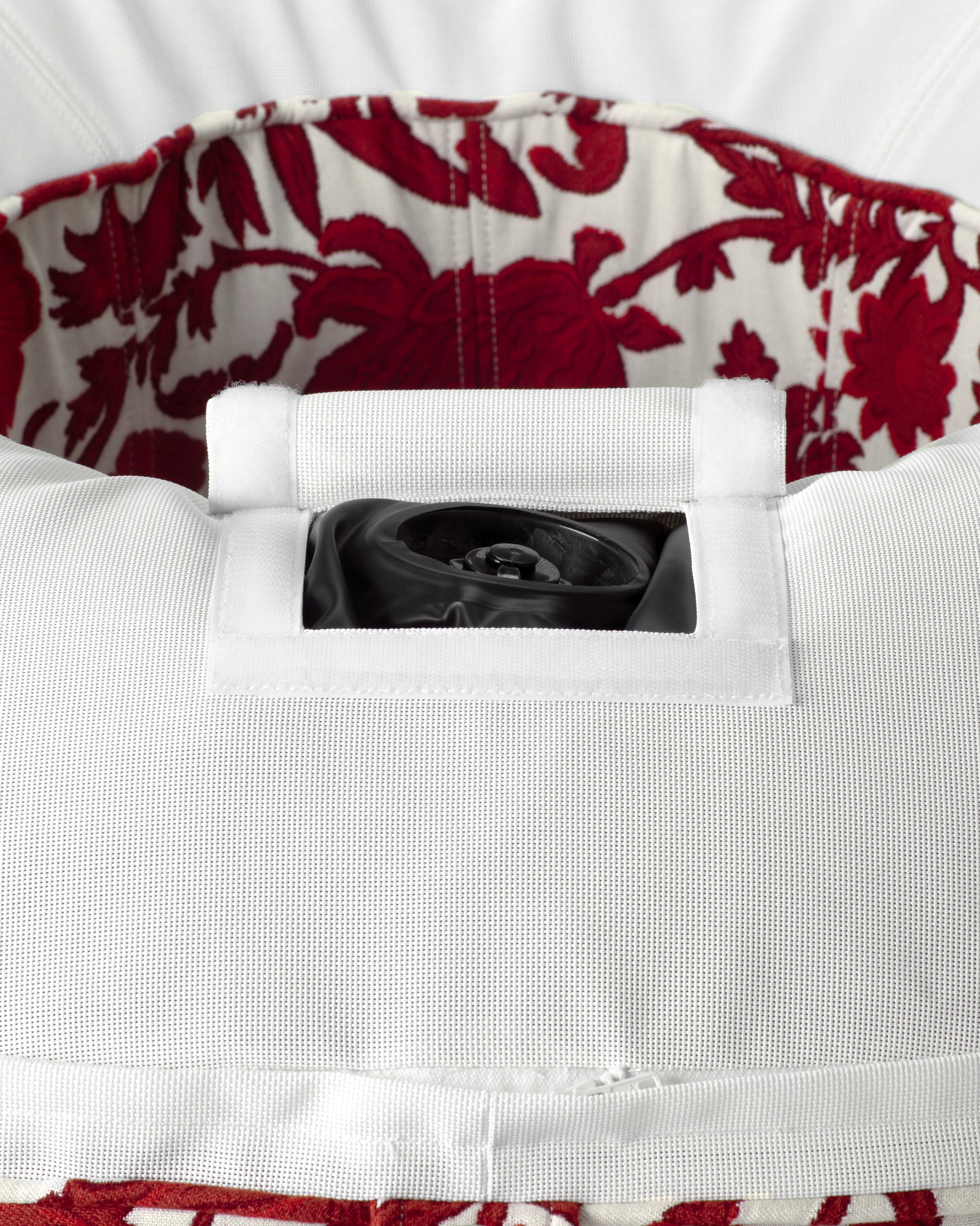 Side profile of the Oliver James inflatable pool ring with red and white flower jacquard fabric and built-in tie-down loops.