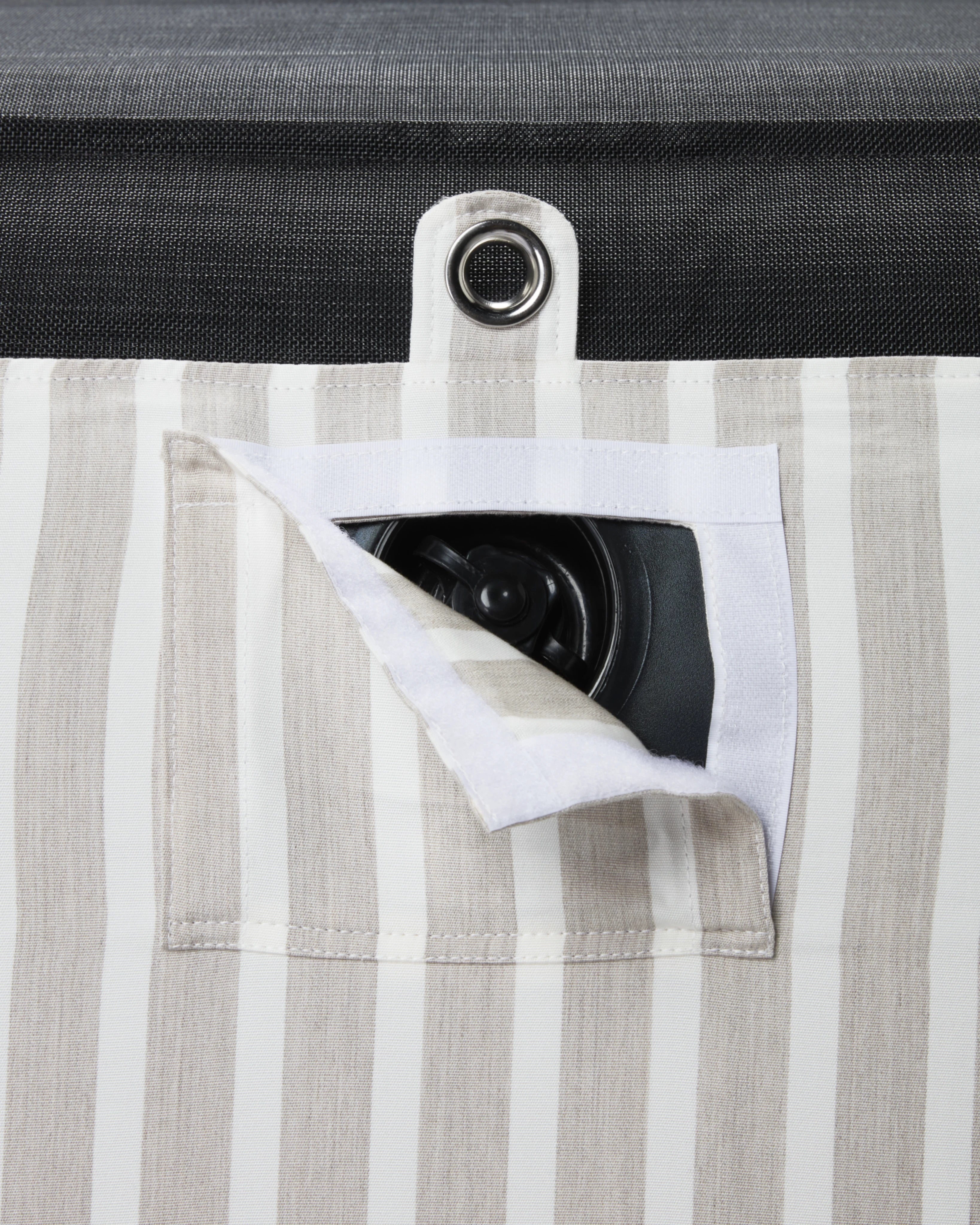 Close-up of concealed inflation valve beneath a neatly stitched flap in beige and white striped fabric, highlighting discreet functional design.