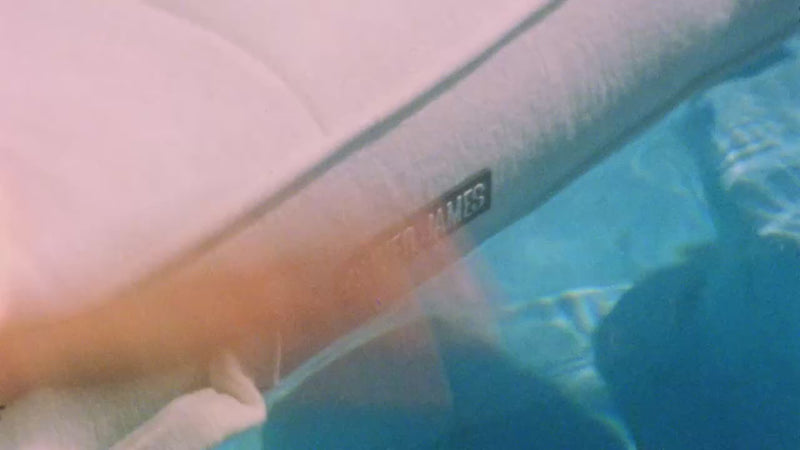 Single luxury pools floats in and around a swimming pool edited using both super eight and digital video clips.