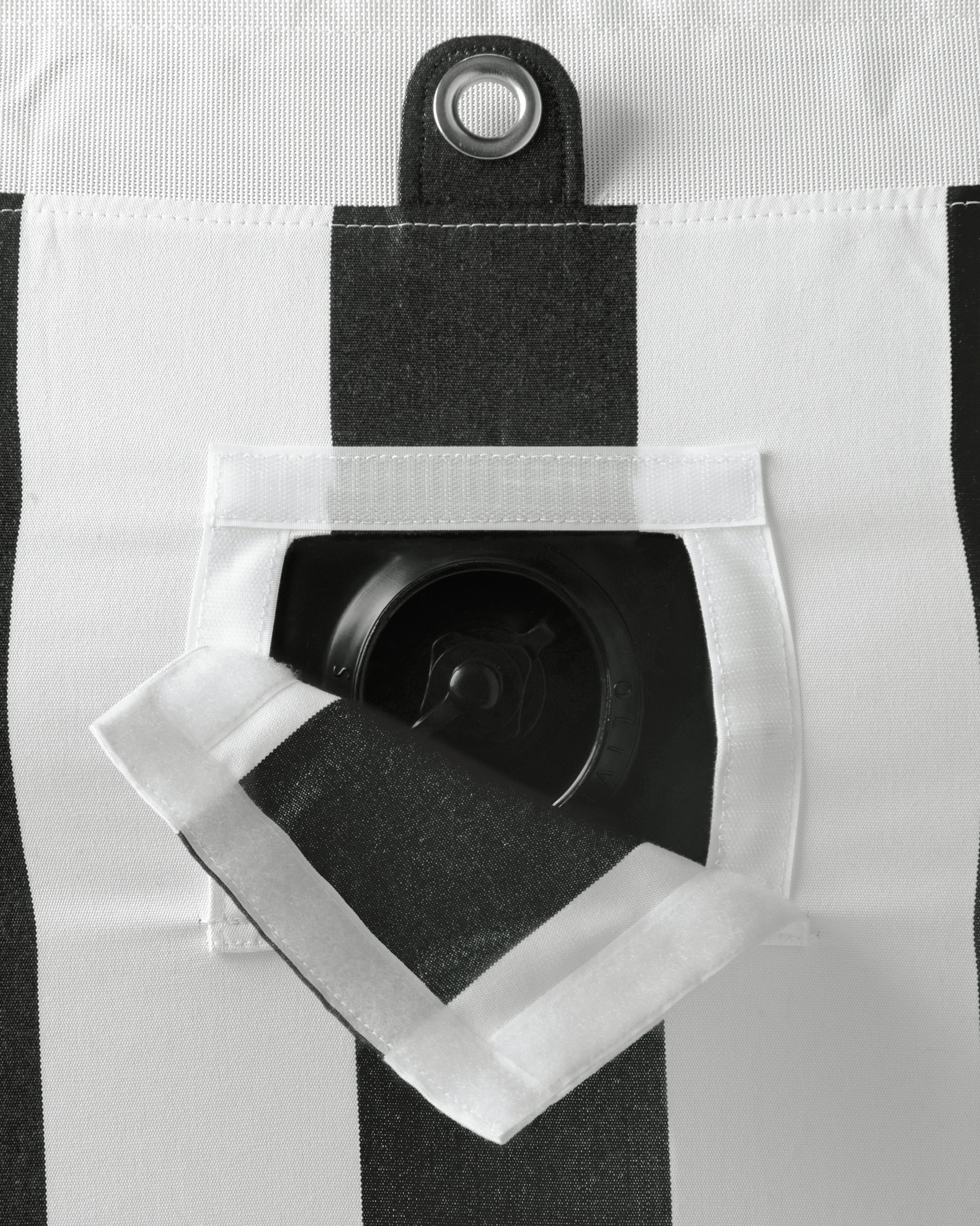 Close-up of concealed inflation valve beneath a neatly stitched flap in black and white striped fabric, highlighting discreet functional design.