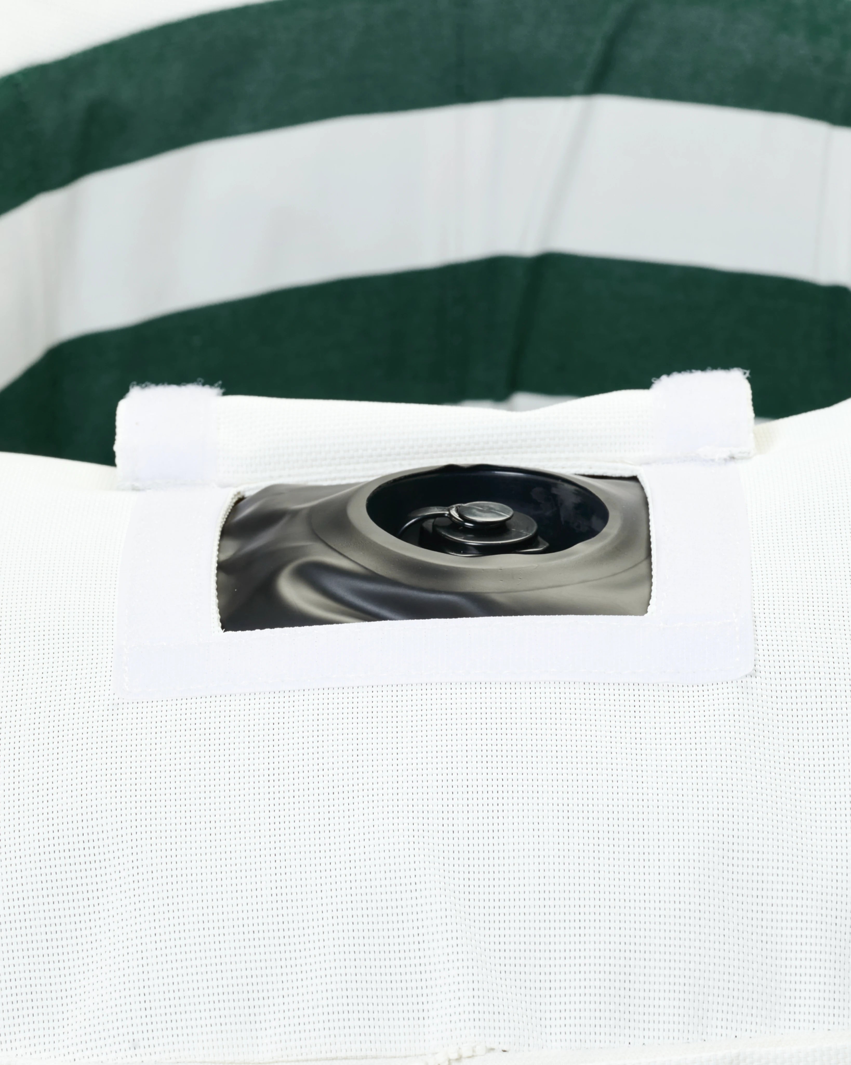 Detail of the hidden inflation valve on the inside seam of the striped round pool float, showcasing discreet functionality and premium construction.